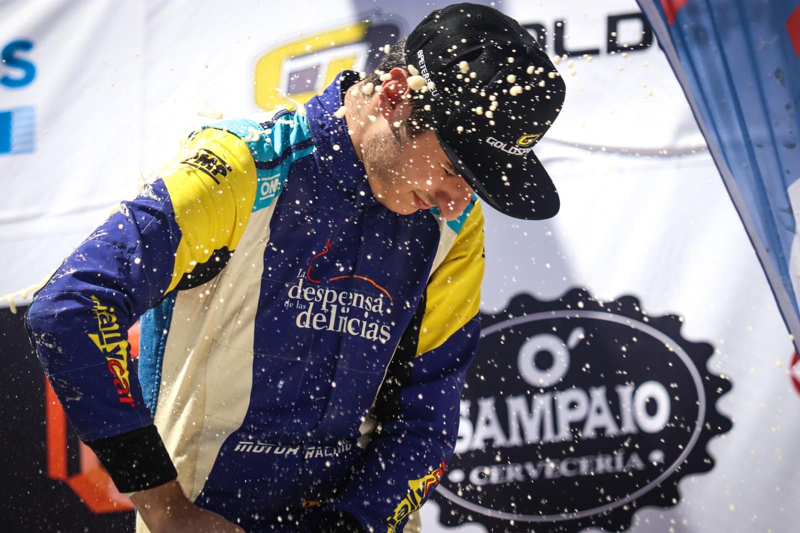 Alejandro Medín celebrando con champán en el podio