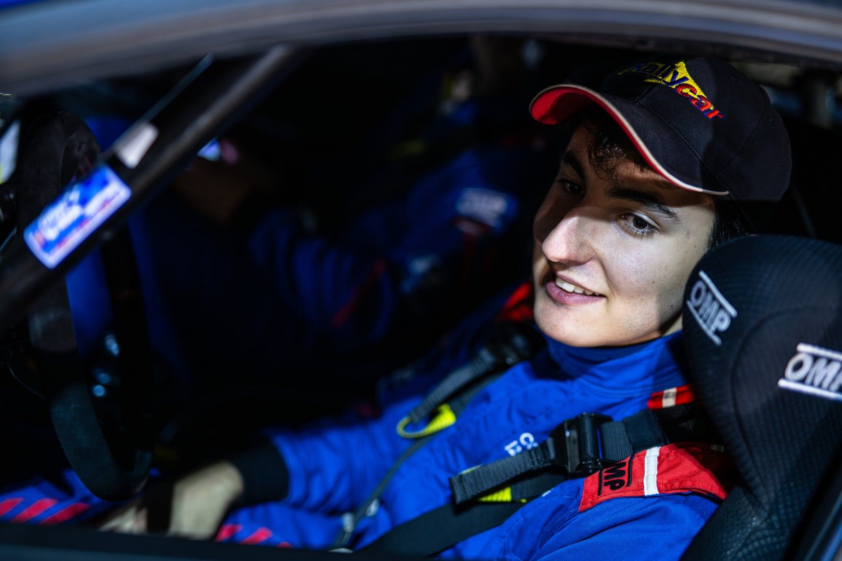 Primer plano de Alejandro Medín sonriendo en el habitáculo de su coche de rally